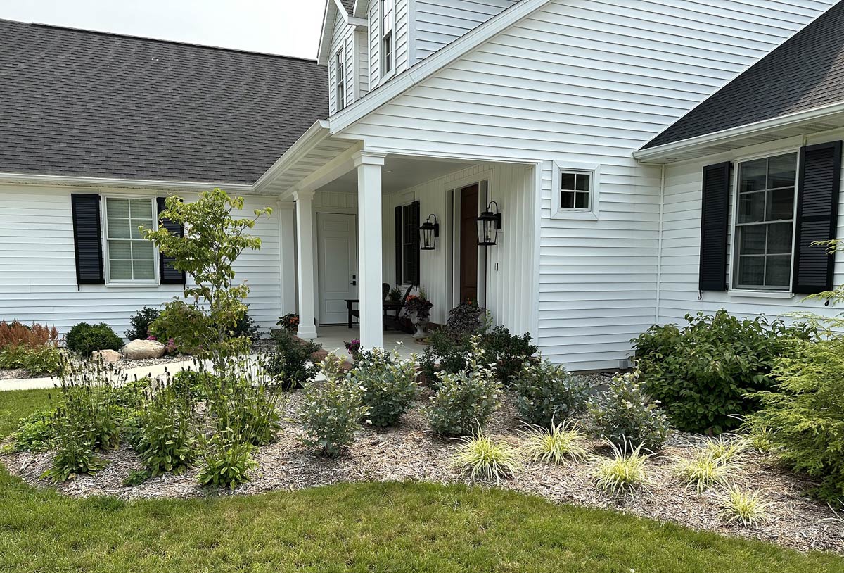 side of home with lawn and plantings done in curve